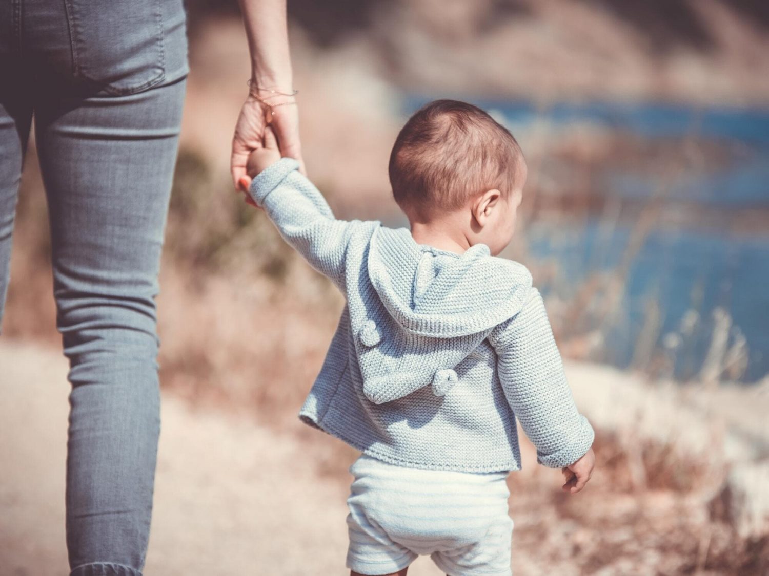 why is positive child guidance important joannabel-a toddler walking with his mother holding hands from behind